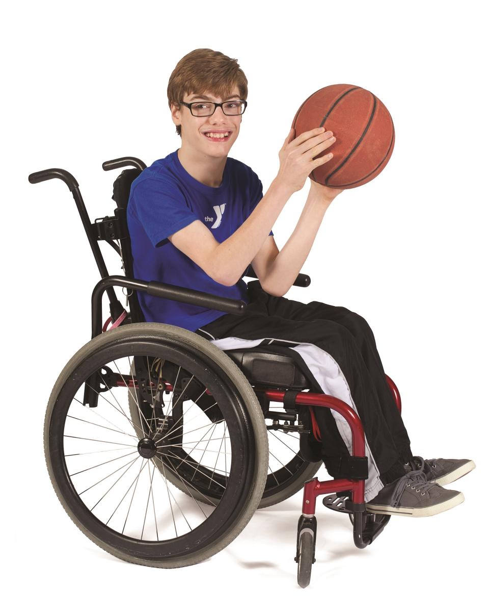 Boy in a wheelchair playing adaptive basketball.