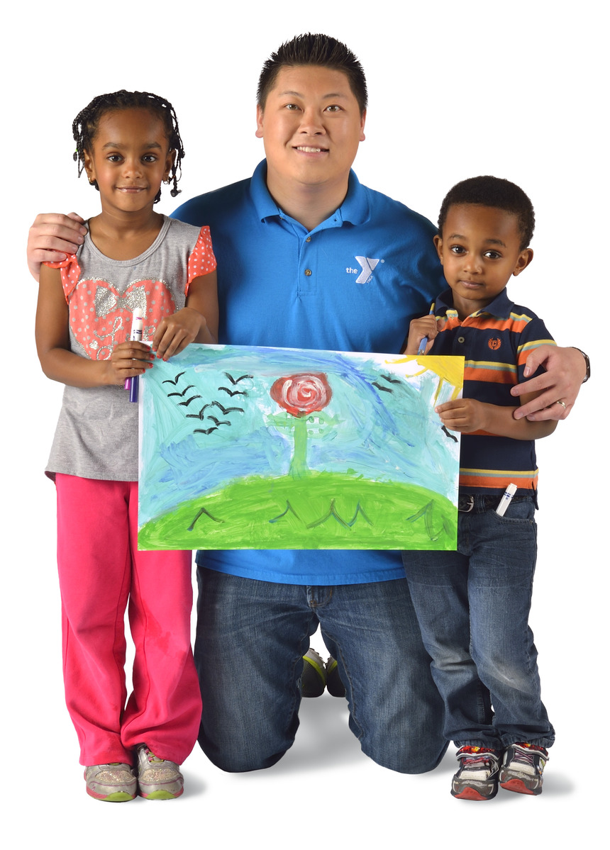 Staff member holding up a picture with two children.