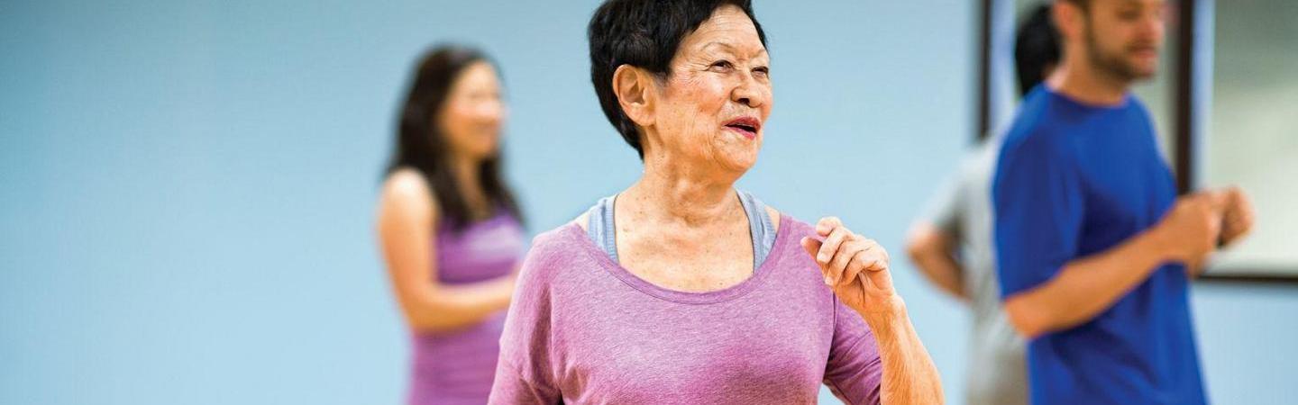 Group of active older adults working out in a class.