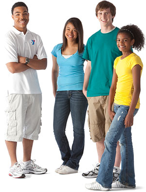Adult staff member posing with three teenagers in a youth education and leadership class.